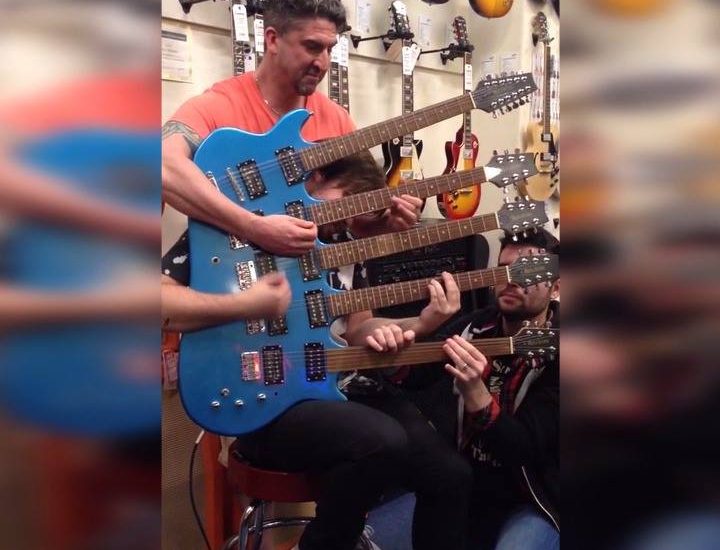 Three Men Play A Five-Necked Guitar