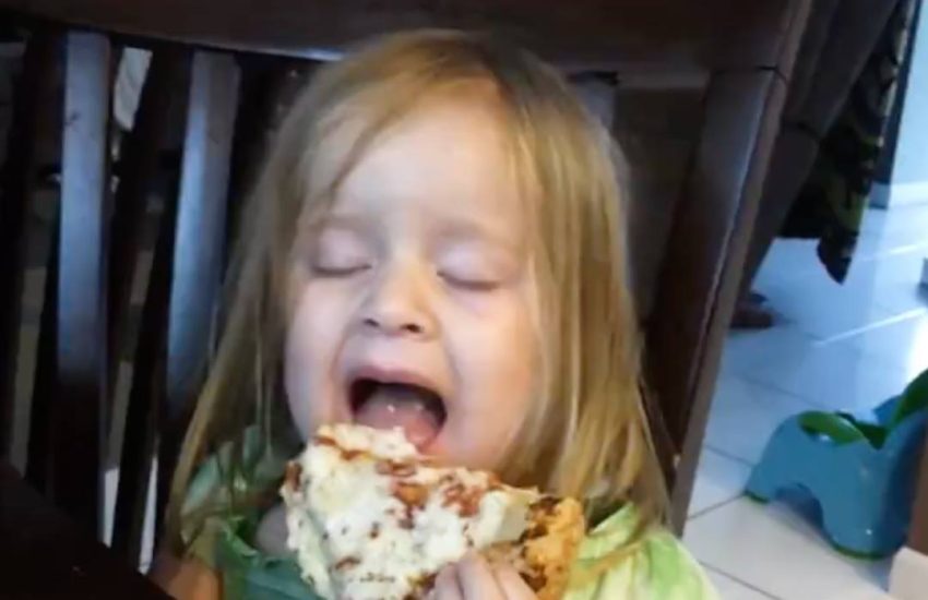 This girl has already figured out that pizza is life